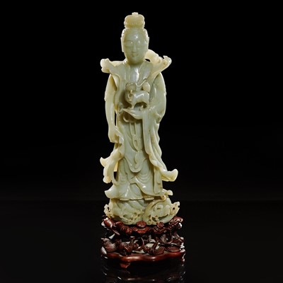 Lot 59 - A large Chinese carved celadon jade figure of a bodhisattva 青玉雕觀音