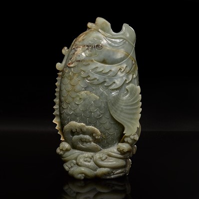 Lot 64 - A Chinese carved celadon jade figure of a leaping carp 青玉鯉躍龍門花插