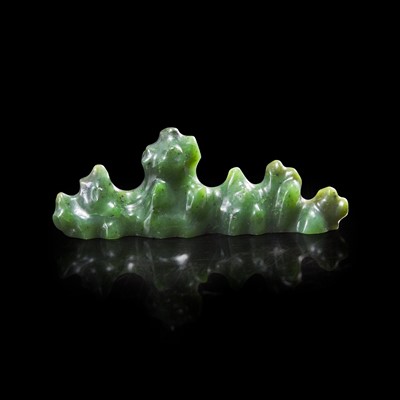 Lot 62 - A Chinese carved spinach jade "Mountain" brush rest 菠菜綠玉筆架