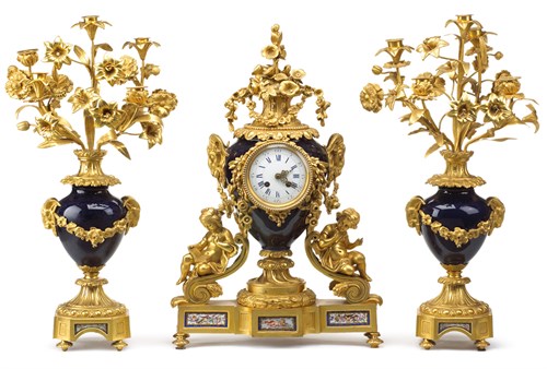Lot 38 - Louis XVI style gilt bronze and cobalt ground porcelain clock garniture