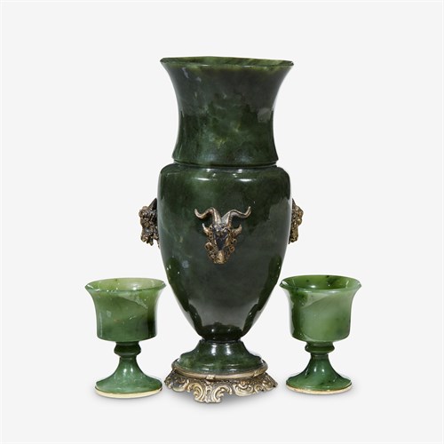 Lot 123 - A Continental style spinach jade vase with applied metal rams heads
