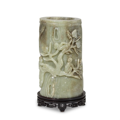Lot 137 - A Chinese carved gray and green jade 'monkey and peach' brush pot