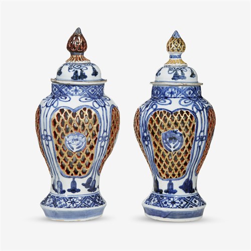 Lot 85 - A pair of Japanese porcelain double-walled vases and covers
