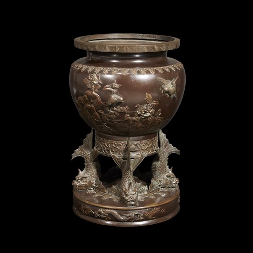 Lot 75 - A Japanese patinated bronze jardiniere with "fish" base