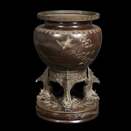 Lot 75 - A Japanese patinated bronze jardiniere with "fish" base