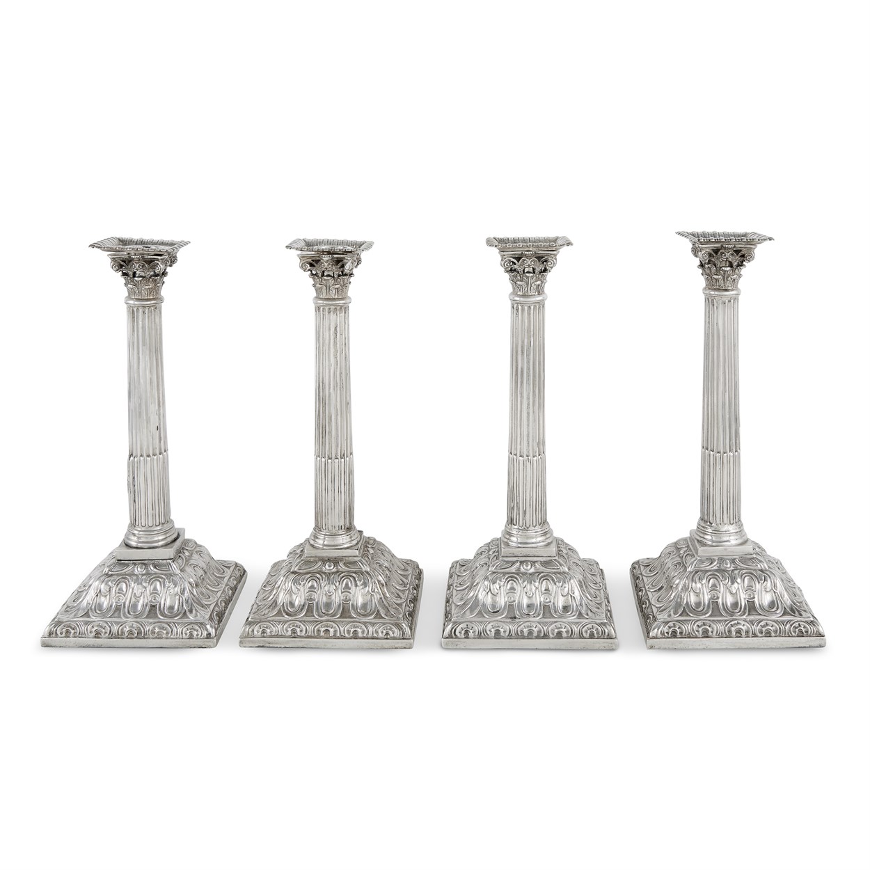 Lot 54 - Four George III sterling silver candlesticks