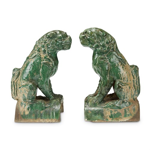 Lot 249 - A pair of green glazed pottery "Lion" roof tiles