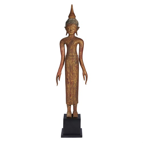 Lot 115 - A Laotian carved and gilt wood figure of a standing Buddha