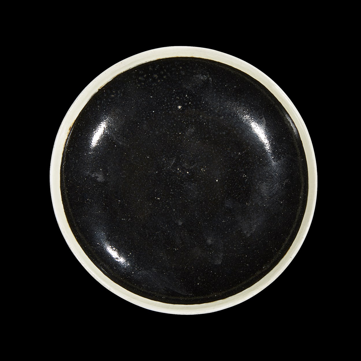 Lot 152 - A Chinese small black-glazed dish with white slip rim
