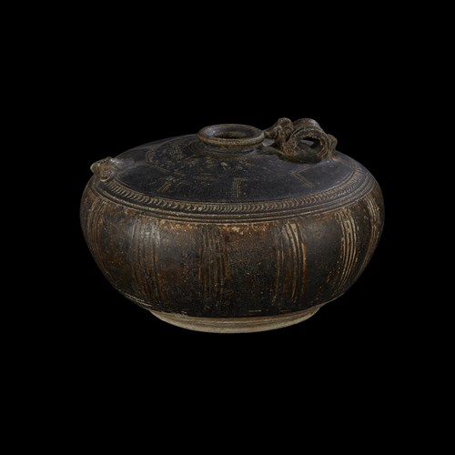 Lot 195 - A Khmer incised and brown-glazed "Owl" jar