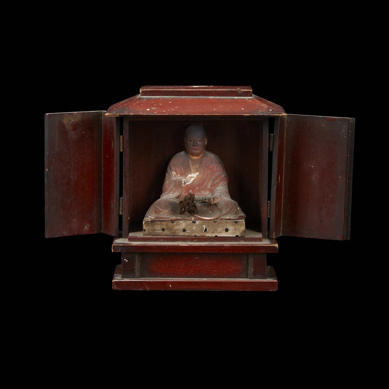 Lot 41 - A Japanese red-lacquered Buddhist shrine, enclosing a monk