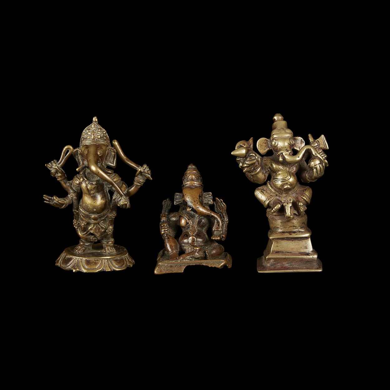 Lot 133 - A group of three Indian copper alloy figures of Ganesha