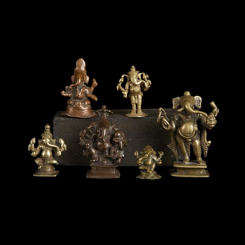 Lot 134 - A group of six Indian copper alloy figures of Ganesha
