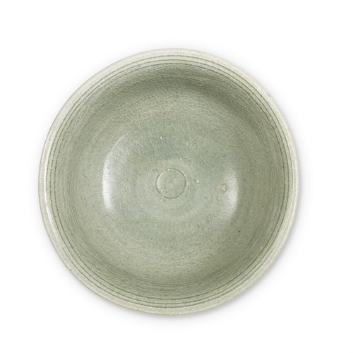 Lot 184 - A Vietnamese incised celadon-glazed bowl, and a Thai celadon-glazed dish and a bowl