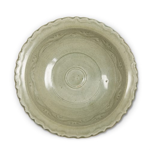 Lot 184 - A Vietnamese incised celadon-glazed bowl, and a Thai celadon-glazed dish and a bowl