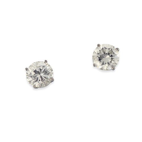Lot 157 - A pair of diamond and fourteen karat white gold studs