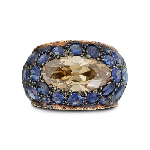 Lot 59 - A fancy yellow brown oval diamond and sapphire ring