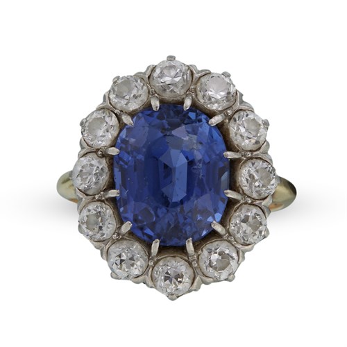 Lot 103 - A sapphire, diamond, platinum and fourteen karat gold ring