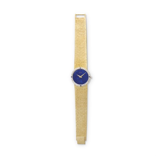 Lot 93 - A lady's eighteen karat gold, diamond, sapphire and lapis lazuli bracelet watch, Piaget