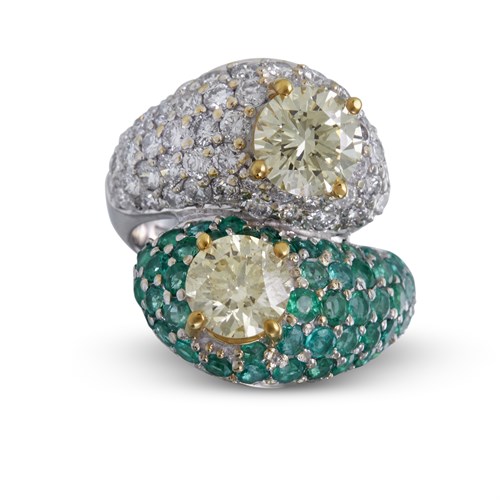 Lot 64 - A colored diamond, diamond, and eighteen karat gold by-pass ring